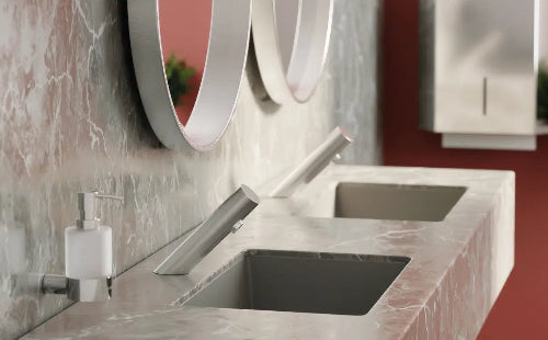 Modern bathroom sink with marble countertop and circular mirror
